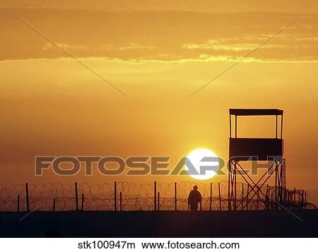 A U. S. Soldier provides protection as the sun rises above the Iraqi desert. View Large Photo Image Picture - A U. S. Soldier provides protection as the sun rises above the Iraqi desert.. Fotosearch