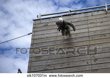 Picture - A U. S. Soldier runs down a 40-foot rappelling wall.. Fotosearch