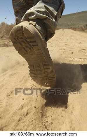 A U. S. soldier walks along a dirt path at a training range near Hawthorne, Nevada. View Large Photo Image Picture - A U. S. soldier walks along a dirt path at a training range near Hawthorne, Nevada.. Fotosearch