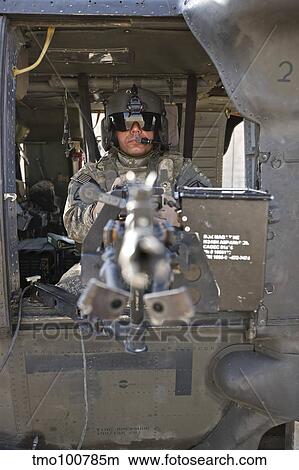 A UH-60 Black Hawk door gunner manning a M240B machine gun. View Large Photo Image Picture - A UH-60 Black Hawk door gunner manning a M240B machine gun.. Fotosearch