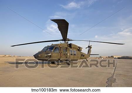 A UH-60 Black Hawk helicopter at Camp Speicher, Iraq. View Large Photo Image Picture - A UH-60 Black Hawk helicopter at Camp Speicher, Iraq.. Fotosearch