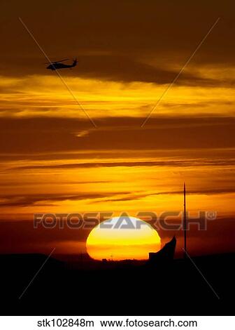 A UH-60 Black Hawk helicopter flies over Joint Base Balad, Iraq. View Large Photo Image Picture - A UH-60 Black Hawk helicopter flies over Joint Base Balad, Iraq.. Fotosearch