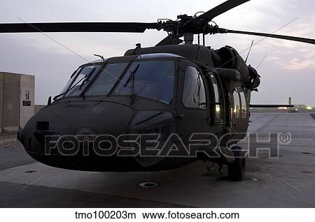 A UH-60 Black Hawk helicopter on the flight line at dusk in Tikrit, Iraq. View Large Photo Image Picture - A UH-60 Black Hawk helicopter on the flight line at dusk in Tikrit, Iraq.. Fotosearch