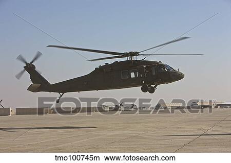A UH-60 Black Hawk landing at a military base in Iraq. View Large Photo Image Picture - A UH-60 Black Hawk landing at a military base in Iraq.. Fotosearch
