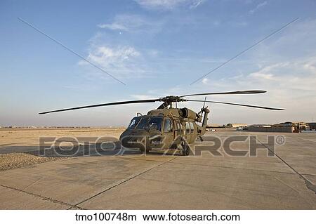 A UH-60 Black Hawk parked at a military base in Tikrit, Iraq. View Large Photo Image Picture - A UH-60 Black Hawk parked at a military base in Tikrit, Iraq.. Fotosearch