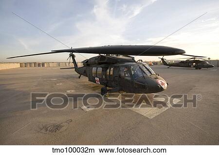 A UH-60 Blackhawk Medivac helicopter sits on the flight deck at Camp Warhorse. View Large Photo Image Picture - A UH-60 Blackhawk Medivac helicopter sits on the flight deck at Camp Warhorse.. Fotosearch