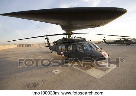 A UH-60 Blackhawk Medivac helicopter sits on the flight deck at Camp Warhorse. View Large Photo Image Picture - A UH-60 Blackhawk Medivac helicopter sits on the flight deck at Camp Warhorse.. Fotosearch