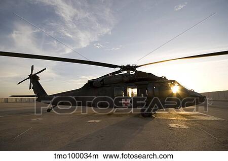 A UH-60 Blackhawk Medivac helicopter sits on the flight deck at Camp Warhorse. View Large Photo Image Picture - A UH-60 Blackhawk Medivac helicopter sits on the flight deck at Camp Warhorse.. Fotosearch