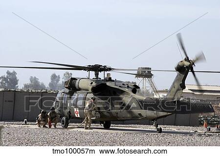 Picture - A UH-60 Blackhawk Medivac helicopter refuels at Camp Warhorse after a mission.. Fotosearch