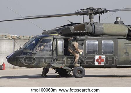 A UH-60 Blackhawk Medivac helicopter refuels at Camp Warhorse after a mission. View Large Photo Image Picture - A UH-60 Blackhawk Medivac helicopter refuels at Camp Warhorse after a mission.. Fotosearch