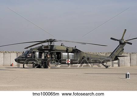 A UH-60 Blackhawk Medivac helicopter refuels at Camp Warhorse after a mission. View Large Photo Image Picture - A UH-60 Blackhawk Medivac helicopter refuels at Camp Warhorse after a mission.. Fotosearch