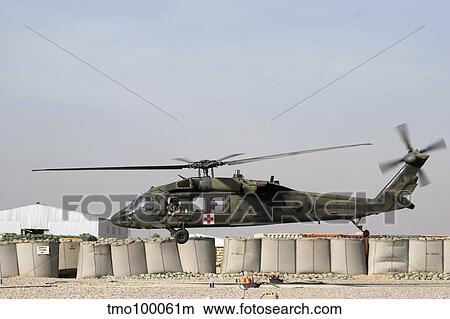 A UH-60 Blackhawk prepares to land at Camp Warhorse to refuel. View Large Photo Image Picture - A UH-60 Blackhawk prepares to land at Camp Warhorse to refuel.. Fotosearch