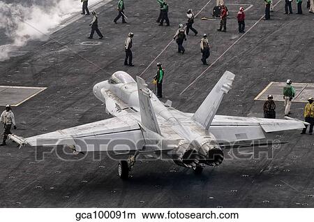A US Navy F/A-18C Hornet on the flight deck of aircraft carrier USS Eisenhower. View Large Photo Image Picture - A US Navy F/A-18C Hornet on the flight deck of aircraft carrier USS Eisenhower.. Fotosearch