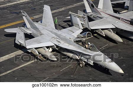 A US Navy F/A-18C Hornet parked on the flight deck of USS Nimitz. View Large Photo Image Picture - A US Navy F/A-18C Hornet parked on the flight deck of USS Nimitz.. Fotosearch