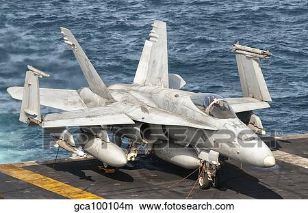 A US Navy F/A-18C Hornet tied on the flight deck of USS Nimitz. View Large Photo Image Picture - A US Navy F/A-18C Hornet tied on the flight deck of USS Nimitz.. Fotosearch