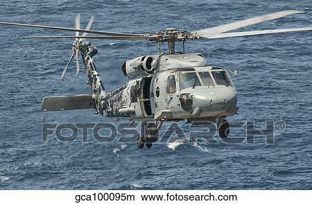 A US Navy SH-60F Seahawk flying off the coast of Pakistan. View Large Photo Image Picture - A US Navy SH-60F Seahawk flying off the coast of Pakistan.. Fotosearch