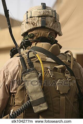 Picture - A vehicle commander with his radio equipment attached to his vest.. Fotosearch