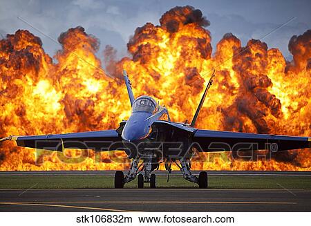 A wall of fire erupts behind a U. S. Navy F/A-18 Hornet aircraft. View Large Photo Image Picture - A wall of fire erupts behind a U. S. Navy F/A-18 Hornet aircraft.. Fotosearch