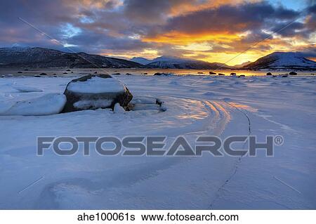 A winter sunset over Tjeldsundet at Evenskjer, Troms County, Norway. View Large Photo Image Stock Photograph - A winter sunset over Tjeldsundet at Evenskjer, Troms County, Norway.. Fotosearch