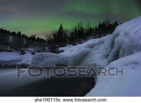 A wintery waterfall and aurora borealis over Tennevik River, Norway. View Large Photo Image Stock Photograph - A wintery waterfall and aurora borealis over Tennevik River, Norway.. Fotosearch