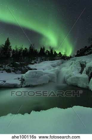 A wintery waterfall and aurora borealis over Tennevik River, Norway. View Large Photo Image Stock Photograph - A wintery waterfall and aurora borealis over Tennevik River, Norway.. Fotosearch