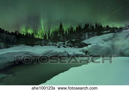 A wintery waterfall and aurora borealis over Tennevik River, Norway. View Large Photo Image Stock Photograph - A wintery waterfall and aurora borealis over Tennevik River, Norway.. Fotosearch