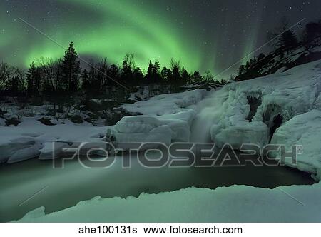 A wintery waterfall and aurora borealis over Tennevik River, Norway. View Large Photo Image Stock Photograph - A wintery waterfall and aurora borealis over Tennevik River, Norway.. Fotosearch