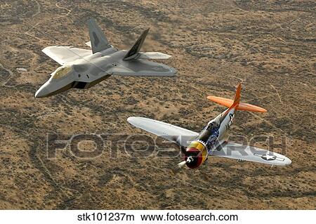 A World War II-era P-47 Thunderbolt and an F-22A Raptor fly in formation. View Large Photo Image Picture - A World War II-era P-47 Thunderbolt and an F-22A Raptor fly in formation.. Fotosearch