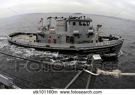 A Yokosuka Naval tugboat prepares to assist the guided missile destroyer USS Curtis Wilbur. View Large Photo Image Picture - A Yokosuka Naval tugboat prepares to assist the guided missile destroyer USS Curtis Wilbur.. Fotosearch