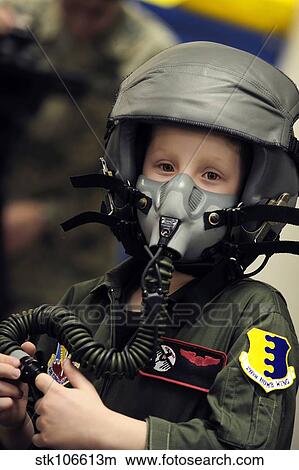 A young boy wears a helmet with oxygen mask attached. View Large Photo Image Picture - A young boy wears a helmet with oxygen mask attached.. Fotosearch