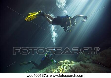 A young married couple scuba diving in Devil's Den Springs Florida. View Large Photo Image Stock Photograph - A young married couple scuba diving in Devil's Den Springs Florida.. Fotosearch