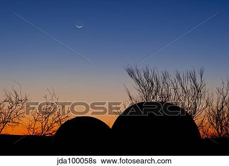 A young moon sets over two domed observatories, Crowell, Texas. View Large Photo Image Stock Photograph - A young moon sets over two domed observatories, Crowell, Texas.. Fotosearch