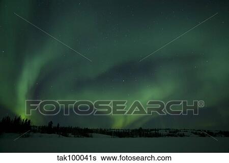 Stock Photograph - Active Aurora over Vee Lake, Yellowknife, Northwest Territories, Canada.. Fotosearch