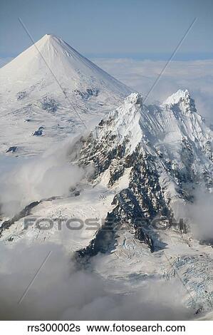 Aerial view of Shishaldin Volcano, with Isanotski Peaks in foreground, Alaska. View Large Photo Image Stock Photograph - Aerial view of Shishaldin Volcano, with Isanotski Peaks in foreground, Alaska.. Fotosearch