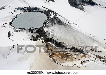 Stock Photograph - Aerial view of snow-covered Ruapehu volcano summit crater with acidic lake, New Zealand.. Fotosearch