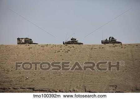 Afghan Army convoy drives along the wadi ridge in Afghanistan. View Large Photo Image Picture - Afghan Army convoy drives along the wadi ridge in Afghanistan.. Fotosearch