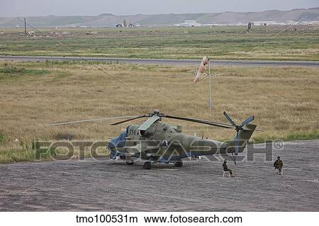 Afghan Army soldiers guard an Mi-35 attack helicopter. View Large Photo Image Picture - Afghan Army soldiers guard an Mi-35 attack helicopter.. Fotosearch