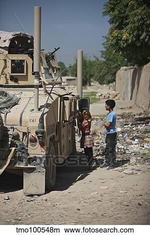 Afghan children ask U. S. soldiers in their humvee for candy. View Large Photo Image Picture - Afghan children ask U. S. soldiers in their humvee for candy.. Fotosearch