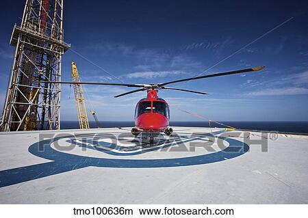 AgustaWestland AW109E utility helicopter on the helipad of an oil rig. View Large Photo Image Picture - AgustaWestland AW109E utility helicopter on the helipad of an oil rig.. Fotosearch