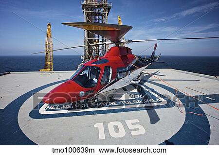AgustaWestland AW109E utility helicopter on the helipad of an oil rig. View Large Photo Image Picture - AgustaWestland AW109E utility helicopter on the helipad of an oil rig.. Fotosearch