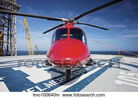 AgustaWestland AW109E utility helicopter on the helipad of an oil rig. View Large Photo Image Picture - AgustaWestland AW109E utility helicopter on the helipad of an oil rig.. Fotosearch