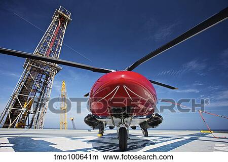 AgustaWestland AW109E utility helicopter on the helipad of an oil rig. View Large Photo Image Picture - AgustaWestland AW109E utility helicopter on the helipad of an oil rig.. Fotosearch