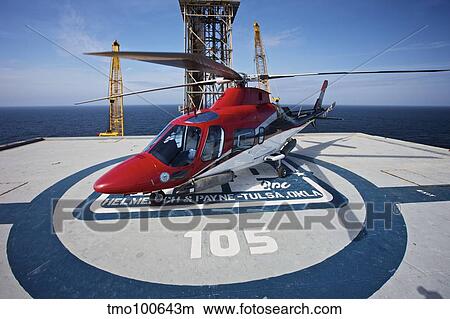 AgustaWestland AW109E utility helicopter on the helipad of an oil rig. View Large Photo Image Picture - AgustaWestland AW109E utility helicopter on the helipad of an oil rig.. Fotosearch