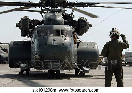 Air crewman gives the engine start up signal to pilots aboard a MH-53E Sea Dragon. View Large Photo Image Picture - Air crewman gives the engine start up signal to pilots aboard a MH-53E Sea Dragon.. Fotosearch