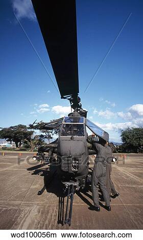 Picture - Air crewmen secure an AH-1 Cobra attack helicopter.. Fotosearch