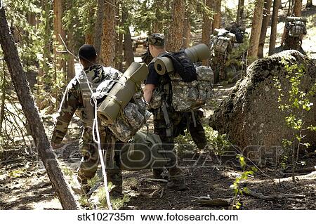 Picture - Air Force Academy cadets enter a wooded area where they will set up camp.. Fotosearch