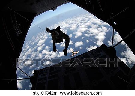 Air Force members practice jumping out of an Air Force C-130 Hercules. View Large Photo Image Picture - Air Force members practice jumping out of an Air Force C-130 Hercules.. Fotosearch