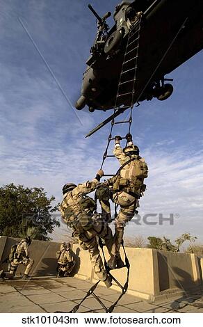 Air Force pararescuemen are extracted by an HH-60G Pave Hawk helicopter. View Large Photo Image Picture - Air Force pararescuemen are extracted by an HH-60G Pave Hawk helicopter.. Fotosearch