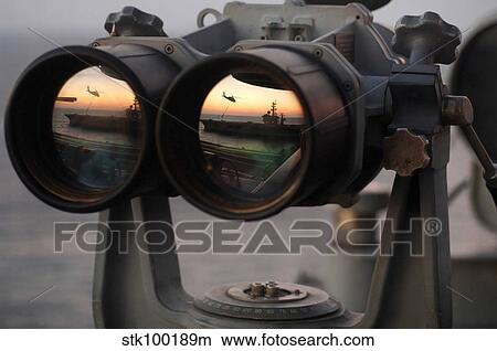 Aircraft carrier USS Dwight D. Eisenhower is reflected in a set of Big Eyes binoculars. View Large Photo Image Picture - Aircraft carrier USS Dwight D. Eisenhower is reflected in a set of Big Eyes binoculars.. Fotosearch