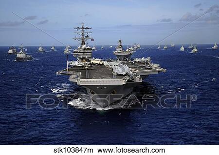 Aircraft carrier USS Ronald Reagan leads a mass formation of ships through the Pacific Ocean. View Large Photo Image Picture - Aircraft carrier USS Ronald Reagan leads a mass formation of ships through the Pacific Ocean.. Fotosearch
